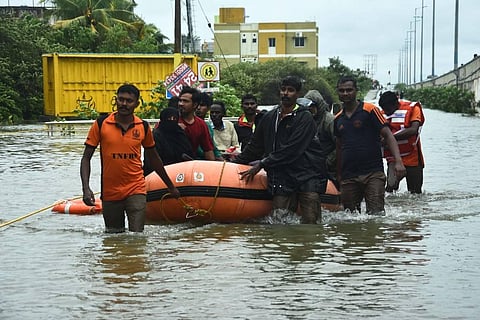 Fire personnel rescue people affected in the flood at Mudichur near Tambaram last week. (Photo | Ashwin Prasath, EPS)
