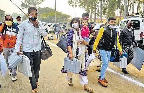 Polling officials carry EVMs and VVPATs as they leave for a station ahead of the UP by-elections in Amroha district | PTI