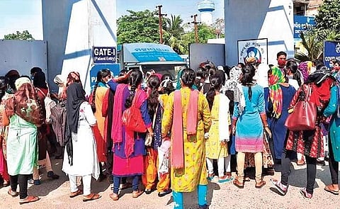 ANMs staging dharna outside Covid hospital in Sambalpur town. (Photo | EPS)