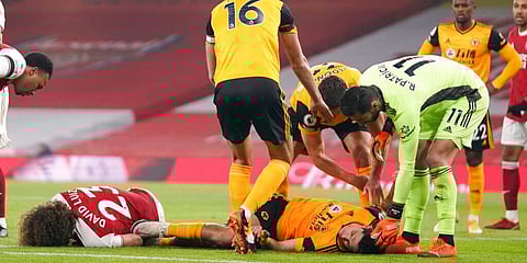 Players attend to Arsenal's David Luiz and Wolverhampton Wanderers' Raul Jimenez following ahead clash. (Photo | AP)