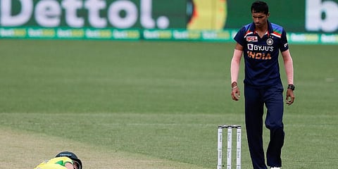 India's Navdeep Saini right watches as Australia's David Warner lies on the pitch. (Photo | AP)