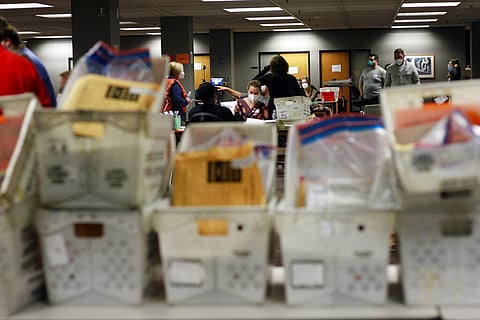 Election workers count absentee ballots into the early morning, Wednesday, Nov. 4, 2020 in Milwaukee at a central counting facility. (Photo | AP)