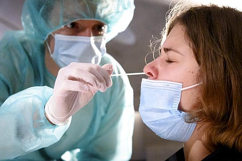 A health worker collects a nose swab sample for a polymerase chain reaction (PCR) test (Photo | AP)