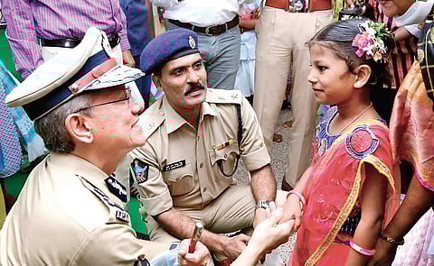 DGP Gautam Sawang speaking to Himabindu during a surprise visit to Good Shepherd Missionary School in Tadepalli on Tuesday | Express