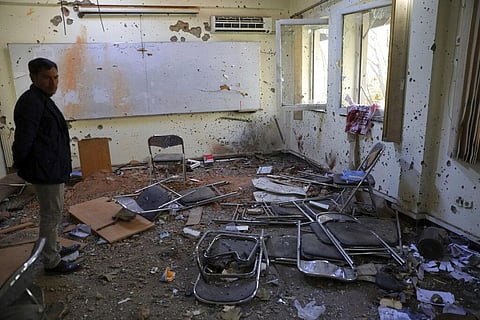 A man stands inside a damaged room at the Kabul University following a deadly attack in Kabul, Afghanistan. (Photo | AP)