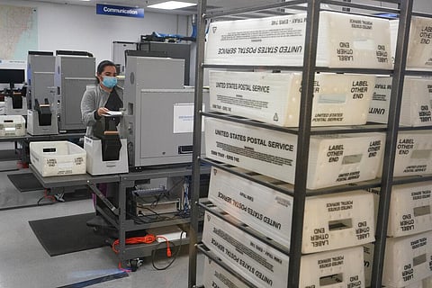 A worker scans and tabulate ballots at the Miami-Dade County Elections Department in Doral, Florida. (Photo | AP)