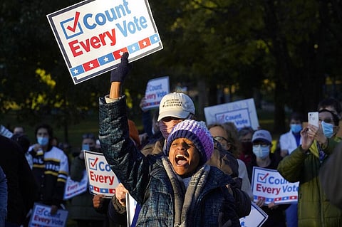 A demonstrator displays a placard, Wednesday, Nov. 4, 2020, during a protest in Boston, as ballots continue to be counted in some battleground states for the general election. (Photo | AP)