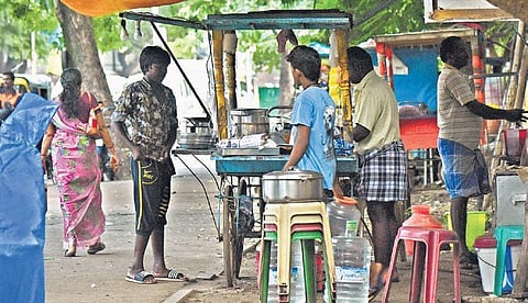 A file picture of a push cart vendor preparing food for his customer