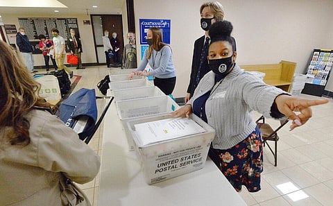 Marian Collin Franco, 20, helps collect provisional ballots at the Erie County Courthouse on Election Day. (Photo | AP)