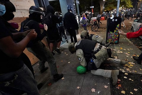 Oregon State Police arrest a protester in Portland. (Photo | AP)