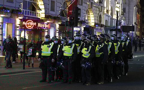A group of police stand on the road as they patrol around 'The Million Mask March', an annual event described as a march 'against austerity, the infringement of rights, war crimes. (Photo | AP)