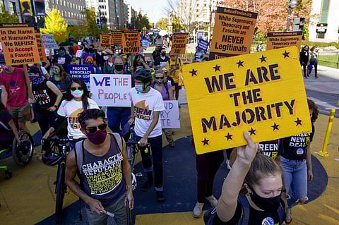 Demonstrators march through Black Lives Matter Plaza as they participate in a Count Every Vote rally, Friday, Nov. 6, 2020, in Washington. (Photo | AP)