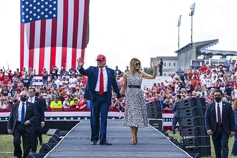 In this Oct. 29, 2020, file photo President Donald Trump walks with first lady Melania Trump after a campaign rally outside Raymond James Stadium in Tampa. (Photo | AP)