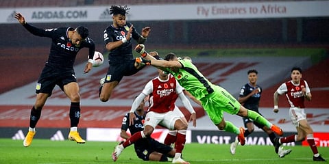 Arsenal goalkeeper Bernd Leno makes a save in front of Aston Villa's Tyrone Mings (top) and Anwar El Ghaz (L) during the English Premier League contest. (Photo | AP)