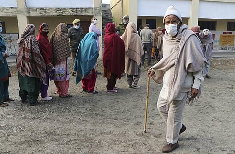 Voters wait in queue during the 2nd phase of the District Development Council election at Bassi Khurd village area of Bari Brahmana in Samba district of Jammu Tuesday. (Photo | PTI)