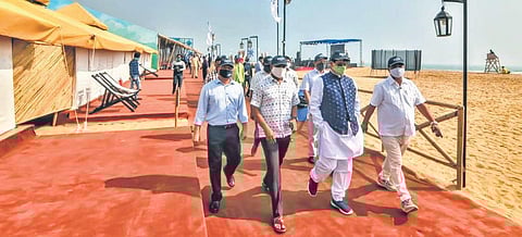 Sports Minister Tusharkanti Behera and School and Mass Education Minister Samir Ranjan Dash on Ramchandi beach | express