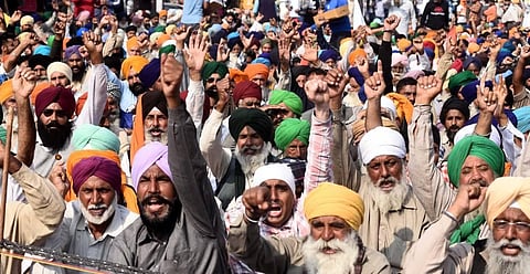 Farmers raise slogans at the Singhu border during their Delhi Chalo protest against the new farm laws in New Delhi on Thursday. (Photo | Parveen Negi/EPS)