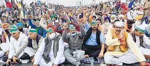 Bharatiya Kisan Union leader Rakesh Tikait along with farmers at a protest rally against the farm laws, at the Delhi-Meerut Expressway, in Delhi on Friday | PTI