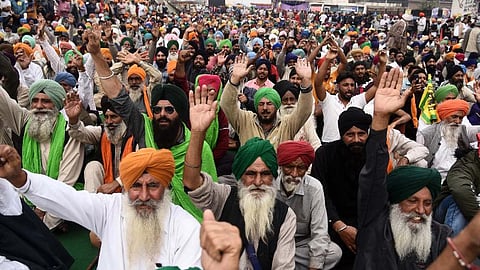 Farmers at Singhu border during their Delhi Chalo protest march against the Centres new farm laws in New Delhi.