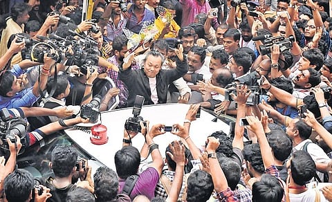 Filmmaker Kim Ki-duk surrounded by lensmen as he departs after participating in a programme held in connection with the 18th International Film Festival of Kerala in T’Puram in 2013 | B P Deepu (file