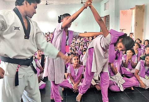 Students practising self-defence techniques.
