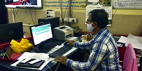 Gandhi Nagar sub-registrar S Mohan verifying the land registration documents of a non-agricultural property on Monday. (Photo| Vinay Madapu, EPS)