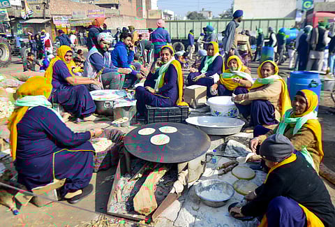 Farmers prepare 'langar' for fellow farmers during their protest against the new farm laws. (Photo| PTI)