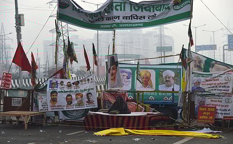 A farmer wraps himself with a shawl on a cold winter morning during their sit-in protest against the Centre's farm laws. (Photo| PTI)