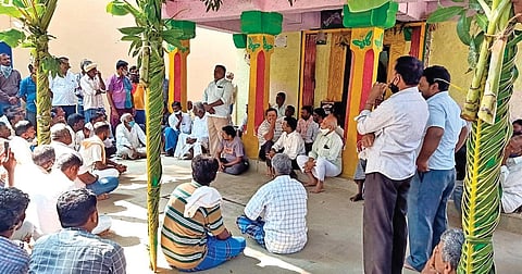 Residents of Honnavalli village gather at a temple to discuss boycott of Gram Panchayat polls in Tiptur taluk on Wednesday. (Photo | Express)