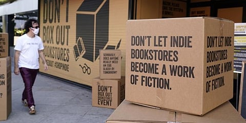 A pedestrian walks past boxes set up in front of book store Book Soup in West Hollywood, Calif., on Oct. 16, 2020, to encourage shoppers to buy from independent book stores. (Photo | AP)