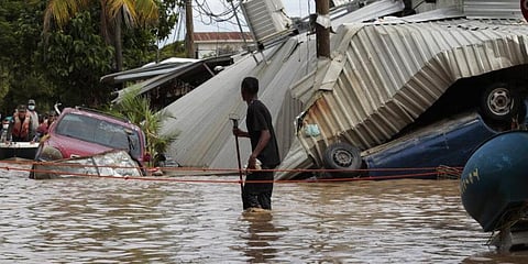 In this November 6, 2020, a resident walking through a flooded street looks back at storm damage caused by Hurricane Eta in Planeta, Honduras. (Photo | AP)