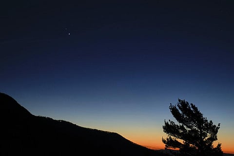 In this Sunday, Dec. 13, 2020 photo made available by NASA, Saturn, top, and Jupiter, below, are seen after sunset from Shenandoah National Park in Luray, Va. (Photo | AP)