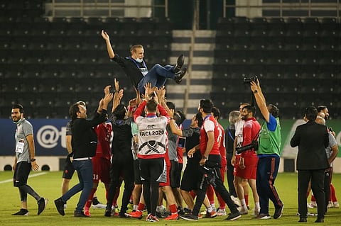 Persepolis' players throw their coach in the air to celebrate their win during the AFC Champions League semi-finals match between Saudi's Al-Nassr and Iran's Persepolis on Oct 3. (File Photo | AFP)