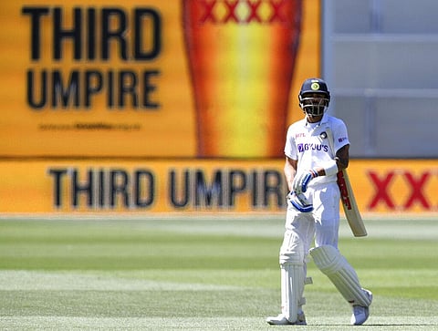 India's Virat Kohli begins to walk off after he was caught out for 4 runs against Australia on the third day of their cricket test match at the Adelaide Oval. (Photo | AP)