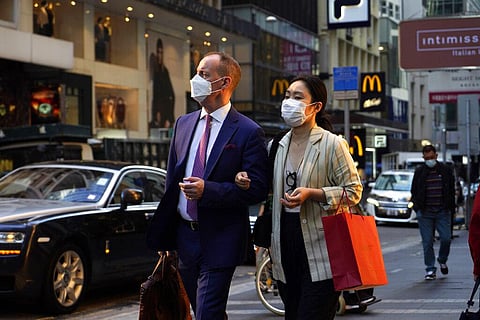 People wearing face masks to protect against the spred of the coronavirus, walk along a street in Hong Kong, Monday, Nov. 30, 2020. (Photo | AP)