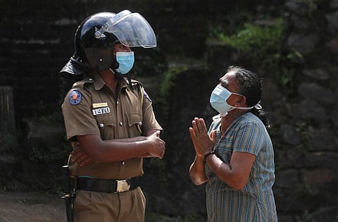 A woman pleads to a cop as she seeks information on the condition of her relative outside the Mahara prison complex following an overnight unrest in Mahara, outskirts of Colombo. (Photo | AP)