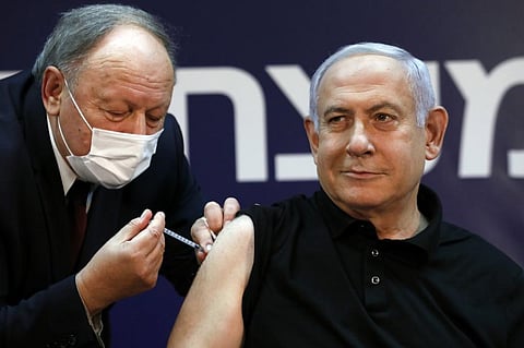 Israeli Prime Minister Benjamin Netanyahu receives a coronavirus vaccine at the Sheba Medical Center. (Photo | AFP)