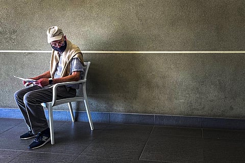 South Africa: A lone man who was just tested for COVID-19 waits. (Photo| AP)