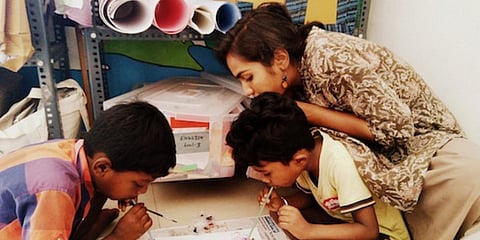 A member of the NGO Hasiru Dala teaches kids in Mysuru. (Photo| Special Arrangement)