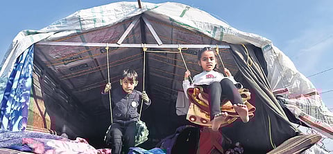 Children use makeshift swings inside a truck during the farmers’ protest at the Ghazipur border. (Photo | Parveen Negi, EPS)