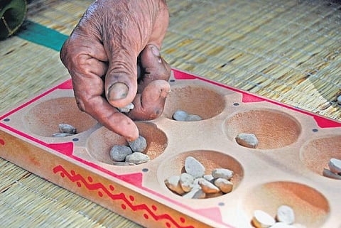 The boards to play the game come in different sizes, metals, and shapes, and have seven pits on two columns, opposite to each other. (Photo| Special Arrangement)