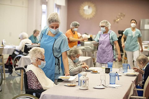 Medical personnel serve food during lunch time at a nursing home in Kaysesberg, eastern France. (Photo | AP)
