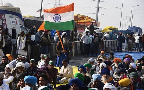 A Nihang holds the Tricolor at Ghazipur border during farmers protest against Centres agri-laws in New Delhi. (Photo | Parveen Negi/EPS)