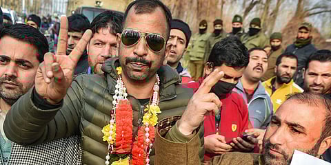Independent candidate Shabir Ahmad flashes victory sign after his lead in the District Development Council DDC election results in Srinagar Tuesday Dec. 22 2020. (Photo | PTI)