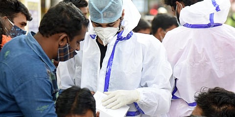 A health worker collects samples in Gandhinagar in Bengaluru on Tuesday. (Photo| Nagaraja Gadekal, EPS)