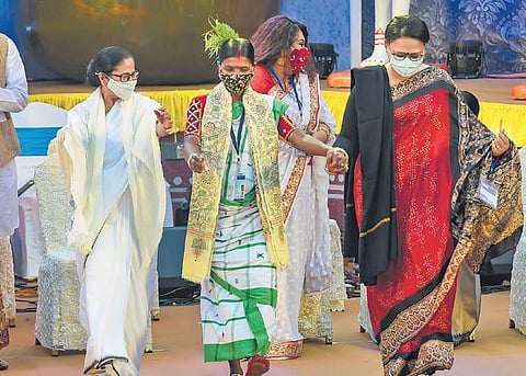 Mamata Banerjee dancing with a tribal woman during the inauguration of the Bangla Sangeet Mela in Kolkata on Wednesday | pti