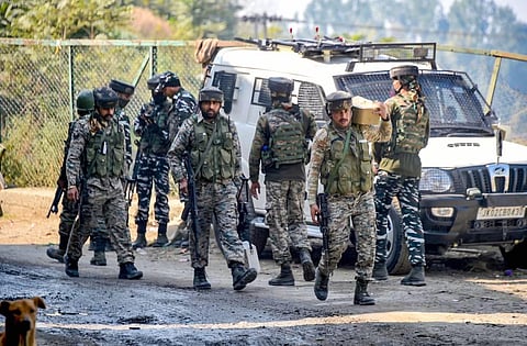 Security personnel stand guard near the site of an encounter with militants. (Photo | PTI)