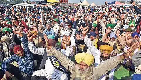 Farmers gesture during their ongoing protest against the new farm sector reform laws, at the Singhu border in Delhi. (Photo | Parveen Negi, EPS)
