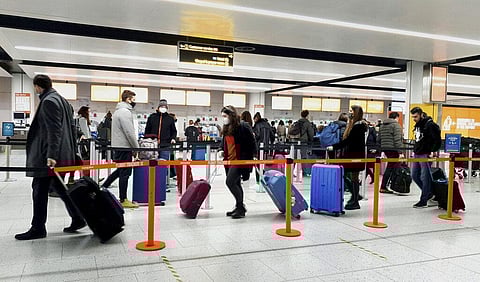 In this Dec. 20, 2020, file photo, passengers queue for check-in at Gatwick Airport in West Sussex, England, south of London. (Photo | AP)
