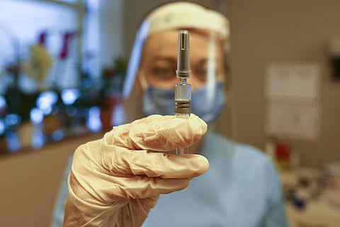 Nurse Arzu Yildirim poses for the photographer as she holds a CoronaVac vaccine, made by Sinovac. (Photo | AP)
